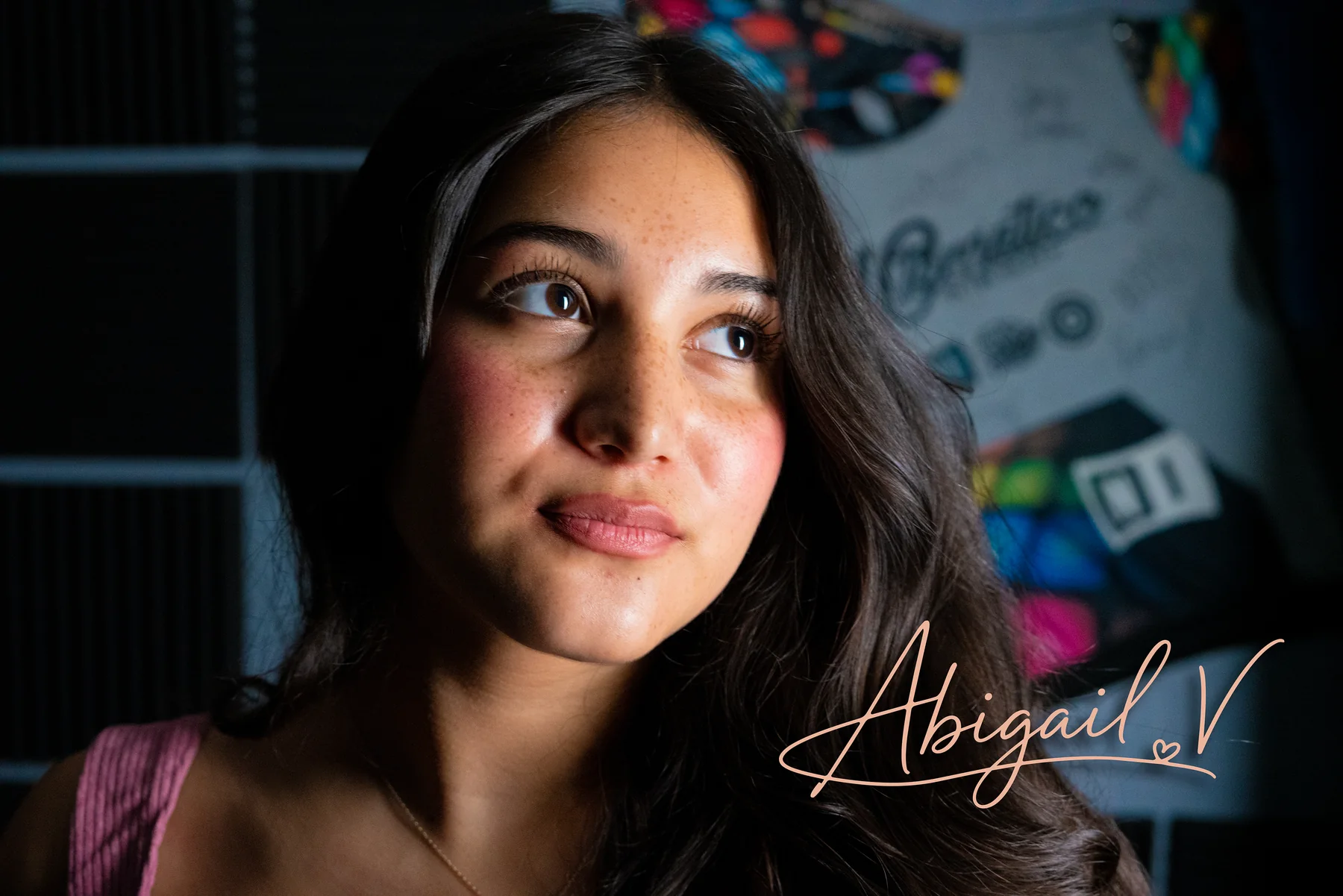 Editorial close-up portrait of Abigail V. in warm studio light.